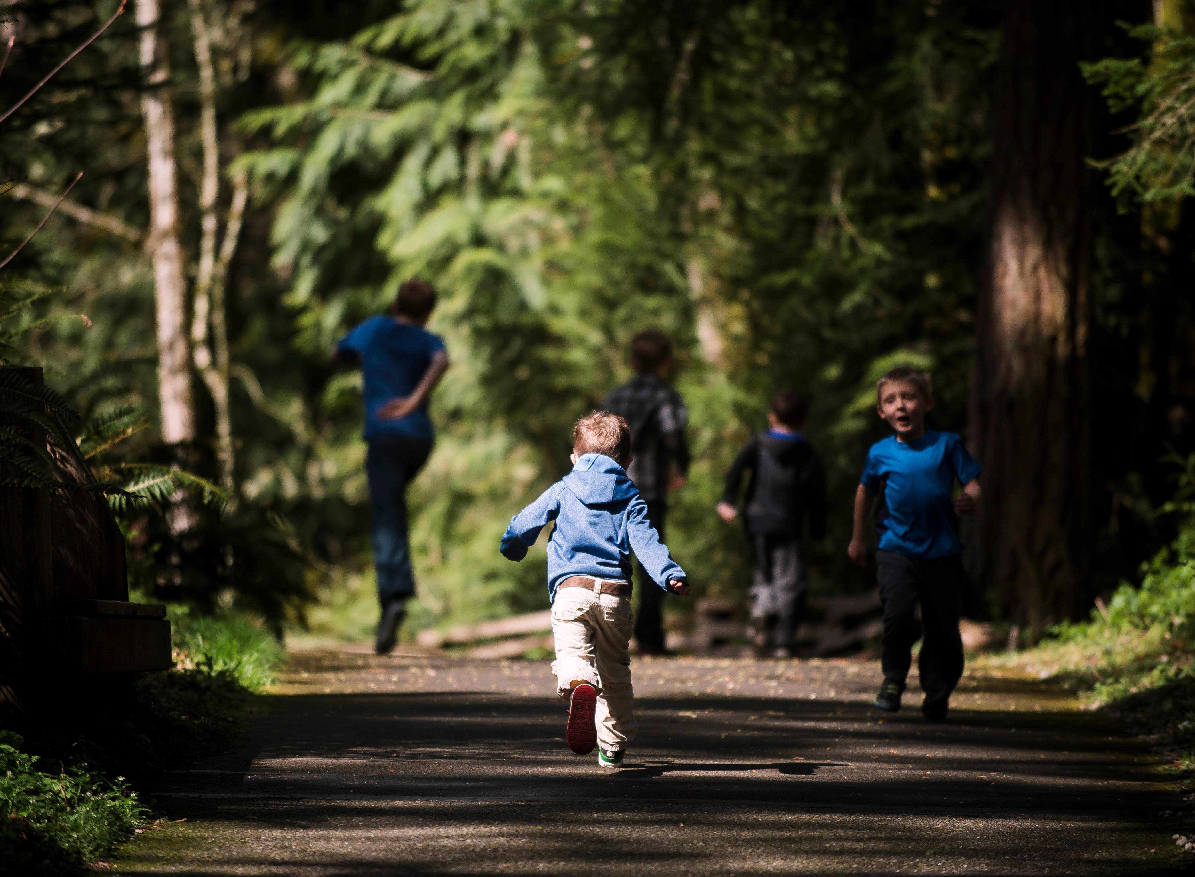 Child running on forest trail