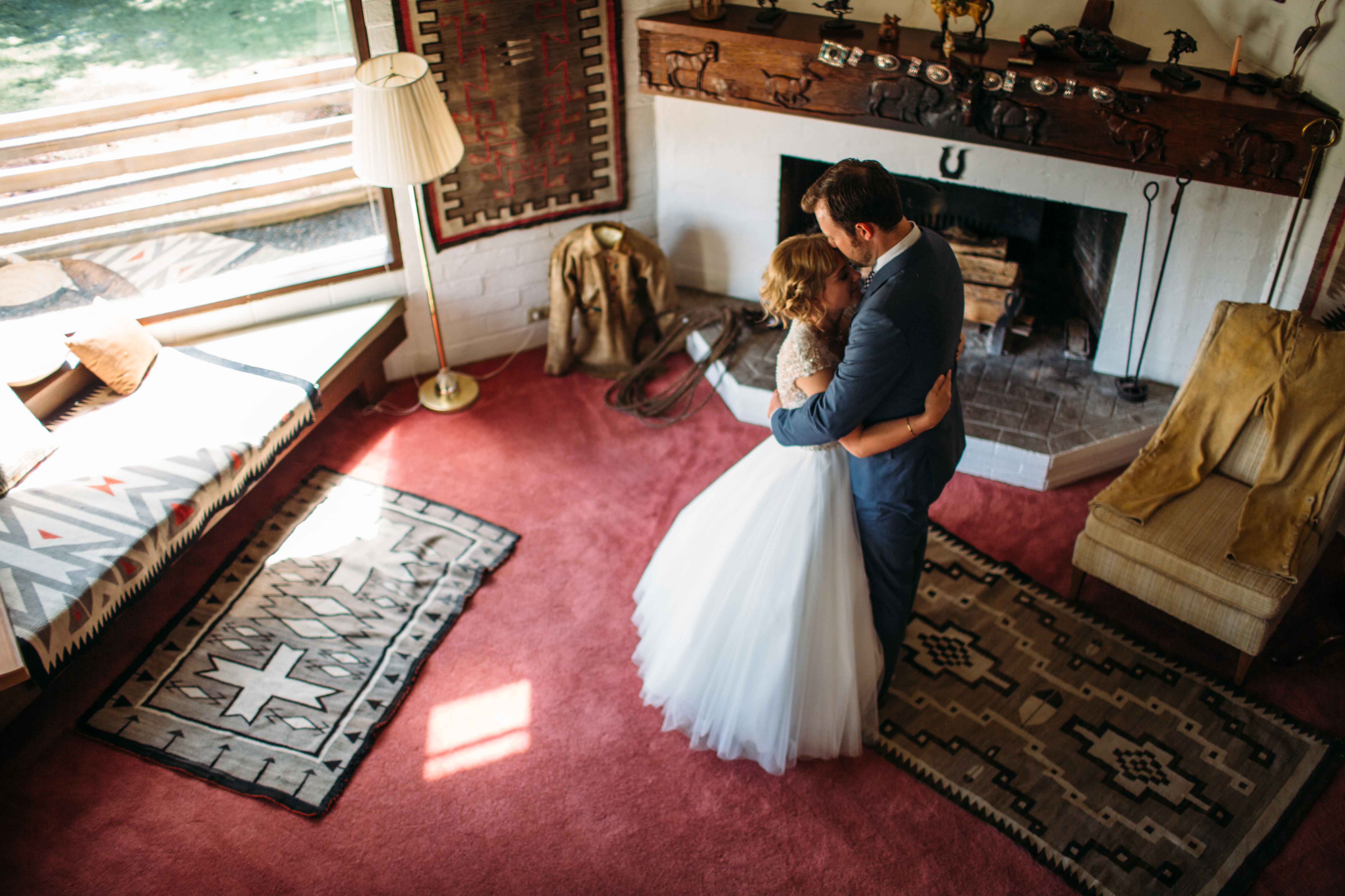 Wedding couple by fireplace